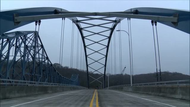 Pictured: The new Savanna Sabula Bridge. The bridge is seen from a street view and has large criss-crossing beams between the two major supports. The bridge aims to optimize transportation between the island town of Sabula, Iowa, and Savanna, Illinois.